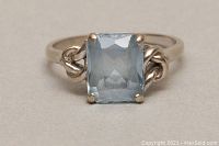 Front view showing the rectangular aquamarine stone set in 10kt gold with decorative linked elements on the band.