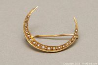 Front view of crescent brooch showing seed pearls