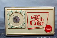 Full front view of rectangular sign with integrated clock and slogan graphic on table background