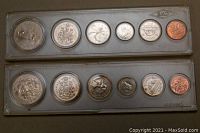 Two Canadian Mint coin sets in plastic holders, arranged flat showing obverse and reverse of coins.