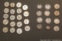Coins arranged flat on gray background showing obverse and reverse sides in groups.