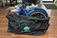 Folded K-ROCK Pioneer bicycle partially inside black carrying bag