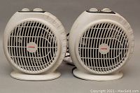 Pair of portable dual heater/fan units side by side showing front and overall design.