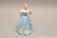 Front view of the Royal Doulton Enchantment figurine showing detailed facial features and flowing blue gown with puffed sleeves.