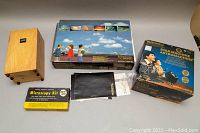 Lot contents including Bushnell Astromachine box, Bausch & Lomb Microscopy kit, wooden box, and weather set boxes and charts.