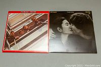 Photo showing both The Beatles 1962-1966 album and John Lennon Double Fantasy album with their covers facing front.