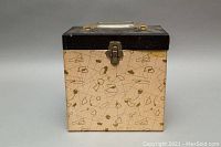 Photo of vintage patterned rectangular box with latch and handle, storing vinyl records