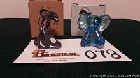Front view of iridescent dolphin and blue elephant figurines with original Fenton boxes