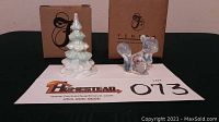 Photo of Fenton French opalescent glass handpainted squirrel and green and white tree with their respective boxes, displayed on a flat surface with lot information.
