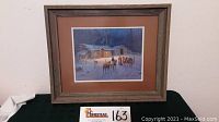 Full view of framed print showing cabin and elk scene.