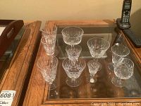 Several types of crystal glasses shown together on a table, illustrating the cut pattern and style representative of the Clapperton crystal collection.