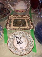 Royal Albert Serina teapot shown with Schumann Bavaria dessert plate beneath and Masons serving plate behind, displaying overall lot composition.