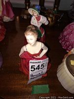 Royal Doulton porcelain figurine of a woman in a flowing red dress, shown from the front with a MaxSold tag on.
