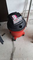 Full view of Sears Craftsman 150 wet/dry vacuum in red and black plastic, drum size approximately 30 litres. Hose is missing as noted.