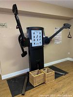 Front view of full FreeMotion cable cross machine showing dual arms and base support.