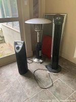Photo showing all three items: Hiland outdoor propane heater, Therapure air purifier, and Seville Classics fan placed on a tiled floor.