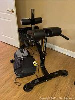 Powertek hyperextension/crunch machine showing padded cylindrical supports and base.