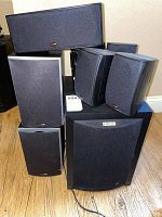 Polk Audio speakers and subwoofer arranged on floor showing all units