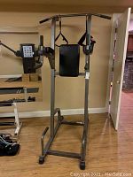 Full front view of the power tower showing pull-up bar, knee-raise station and dip handles