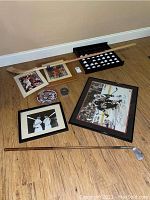 Overhead view of all items arranged: hockey photo, hockey stick, golf balls, additional photos, plate, puck