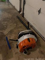 Full unit on garage floor with blower tube attached