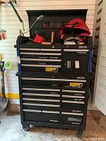 Front view of the two-piece Kirkland Signature tool chest with top lid open showing interior storage and various items (not included).