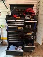 Full view of two-piece Kirkland Signature tool chest with upper lid open and several drawers extended