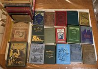 17 books laid out on table, front covers and spines visible