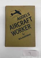 Front cover of the book, brown cloth with black airplane icon and title text.