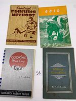 Four vintage booklets with varied cover designs placed on white surface.