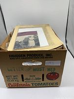 Cardboard California tomatoes box filled with plastic sleeves and paper ephemera