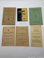 Overview of six military booklets and pamphlets including Canadian Army training manuals and a German language booklet.
