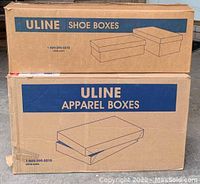 Two stacked cardboard cases, upper labeled as Uline Shoe Boxes and lower labeled as Uline Apparel Boxes showing branding and box illustrations.