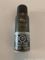 Front view of unopened Behr Chalk Decorative Paint spray can in Classic Noir black color showing extreme danger warnings.