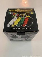 Retail box of Drill Brush Power Scrubber Set showing brush colors and product branding.