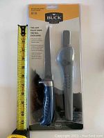 Front view of unopened Buck Knives 223 Silver Creek fillet knife package with ruler for size reference