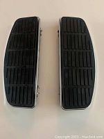 Top view of the pair of Harley Davidson floorboards showing black rubber tread surfaces.