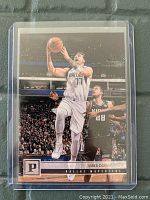 Front side of Luka Doncic basketball card showing player in action with Dallas Mavericks uniform and Panini branding.