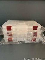Stack of three small Plano Stowaway tackle boxes unopened in plastic wrapping.