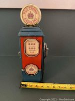 Front and right side angled view of the retro gas pump decoration, showing Red Crown Gasoline logos and details with measuring tape for scale.