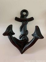 Front view of metal anchor-shaped towel hook with rope detail.