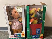 Boxed Tigger figure holding a decorated Christmas tree, dressed in festive outfit.