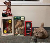 Lot of five Christmas-themed animated figures and one plush cat with battery wiring. Includes reindeer, teddy bears, Santa figure, cat with battery.