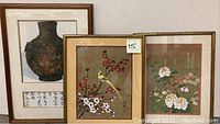 Three framed watercolor paintings arranged side by side