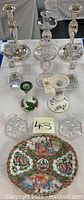 Full set of candlesticks and Rose Medallion bowl on white table, showing layout and variety of styles