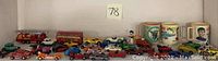 Wide view of all toys including Star Trek mugs and a variety of colorful toy cars arranged in a row.