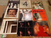 First image showing a selection of vinyl records including The Knack, Burton Cummings, INXS, Africville, and The Romantics