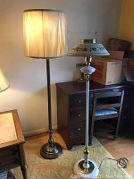 Photo showing a pair of floor lamps side by side, highlighting their size difference and distinct shades.
