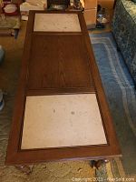 Top view of the wooden coffee table showing two stone rectangular insets separated by a wood panel in the middle. Table measures approximately 52 x 20 inches.
