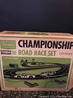 Front and side views of the vintage Sears Championship Road Race Set box with 1/32 scale track illustration and cars.